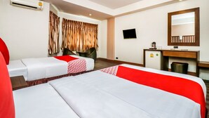 A hotel room with two beds, a desk, a chair, a TV, and an air conditioning unit. - Ultimate Twin Stay | Cozy, Smart Comfort (Pattaya)