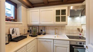 Fridge, stovetop, dishwasher, coffee/tea maker