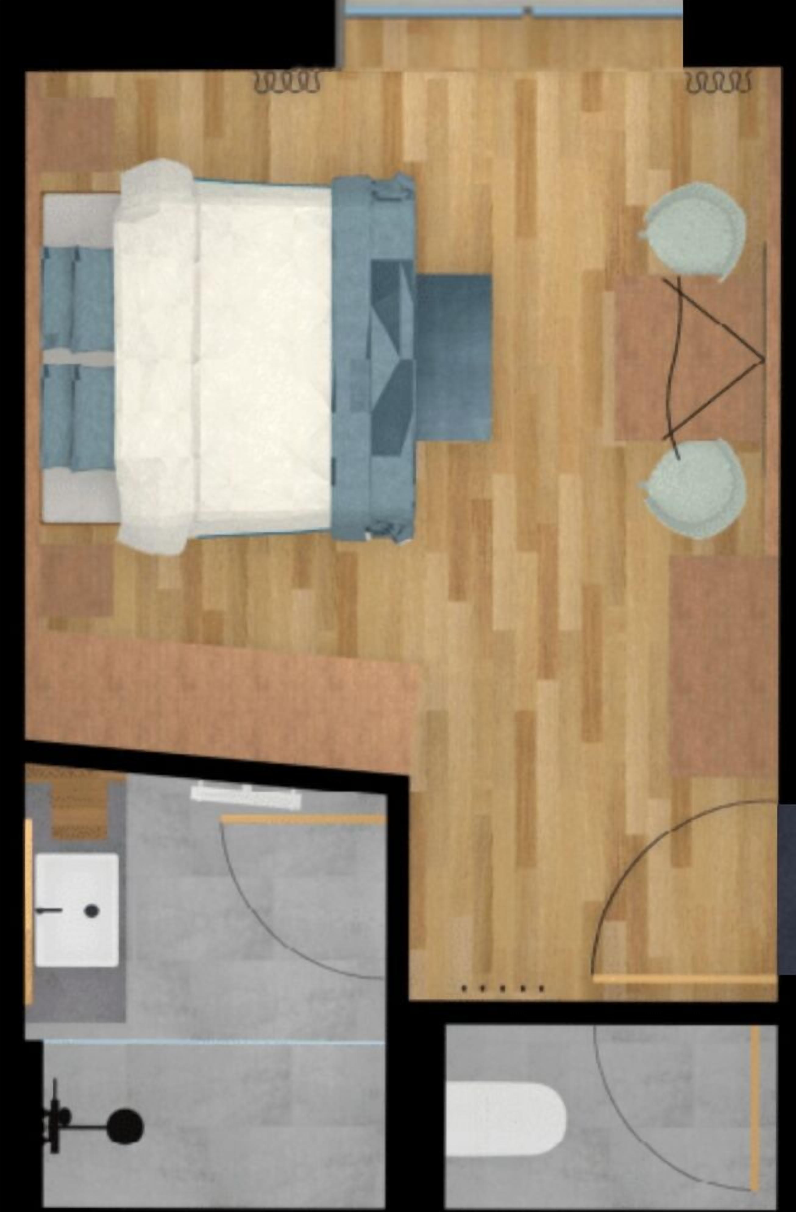 Ein Zimmer mit einem Bett, einem kleinen Tisch und einem Stuhl. Es gibt ein Badezimmer mit Toilette und Waschbecken.