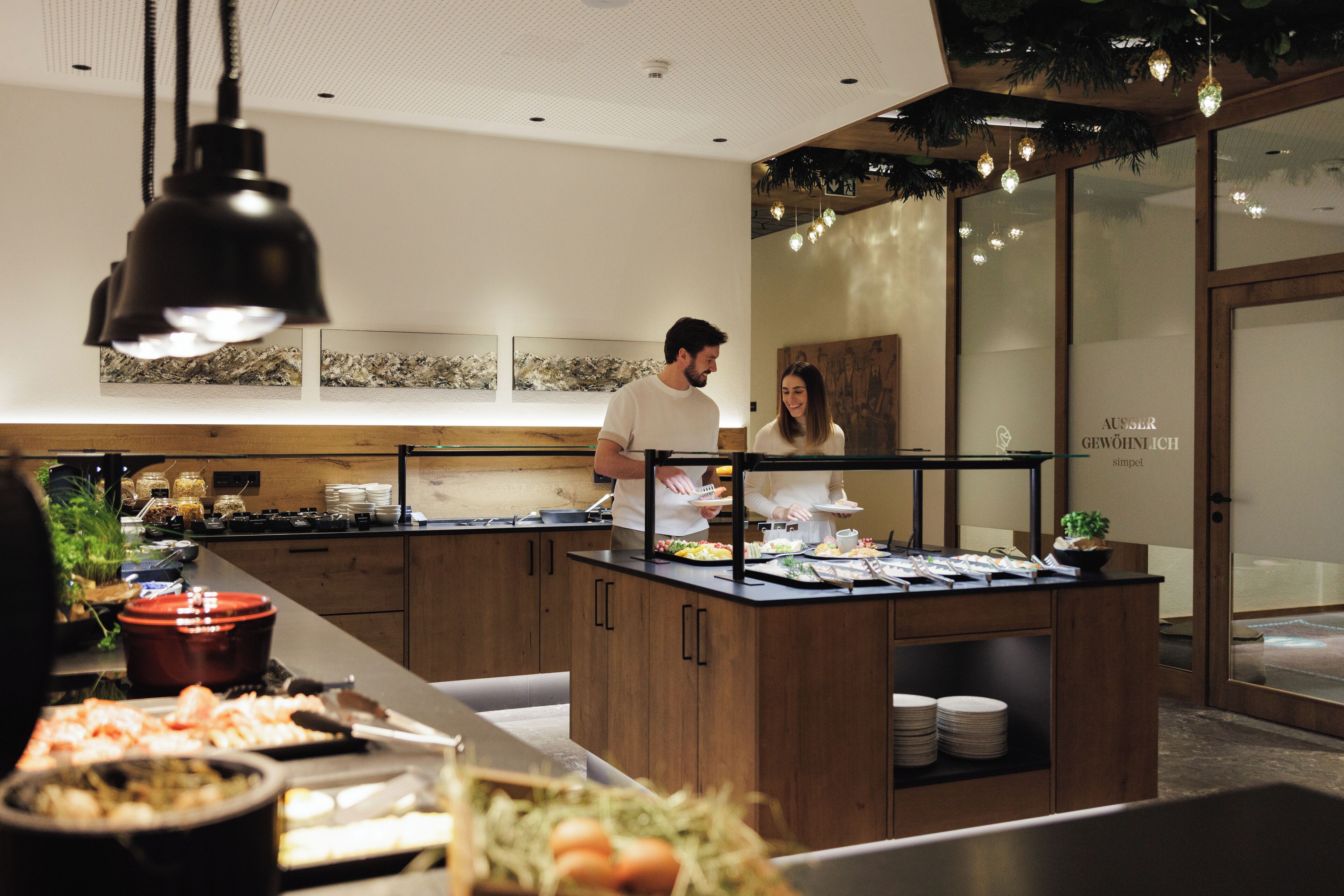 A buffet setup with a variety of food items and a counter where staff are serving.