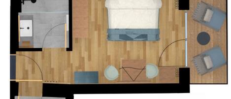 A hotel room layout with a bed, two seating areas, a small table, a sink, and a toilet.
