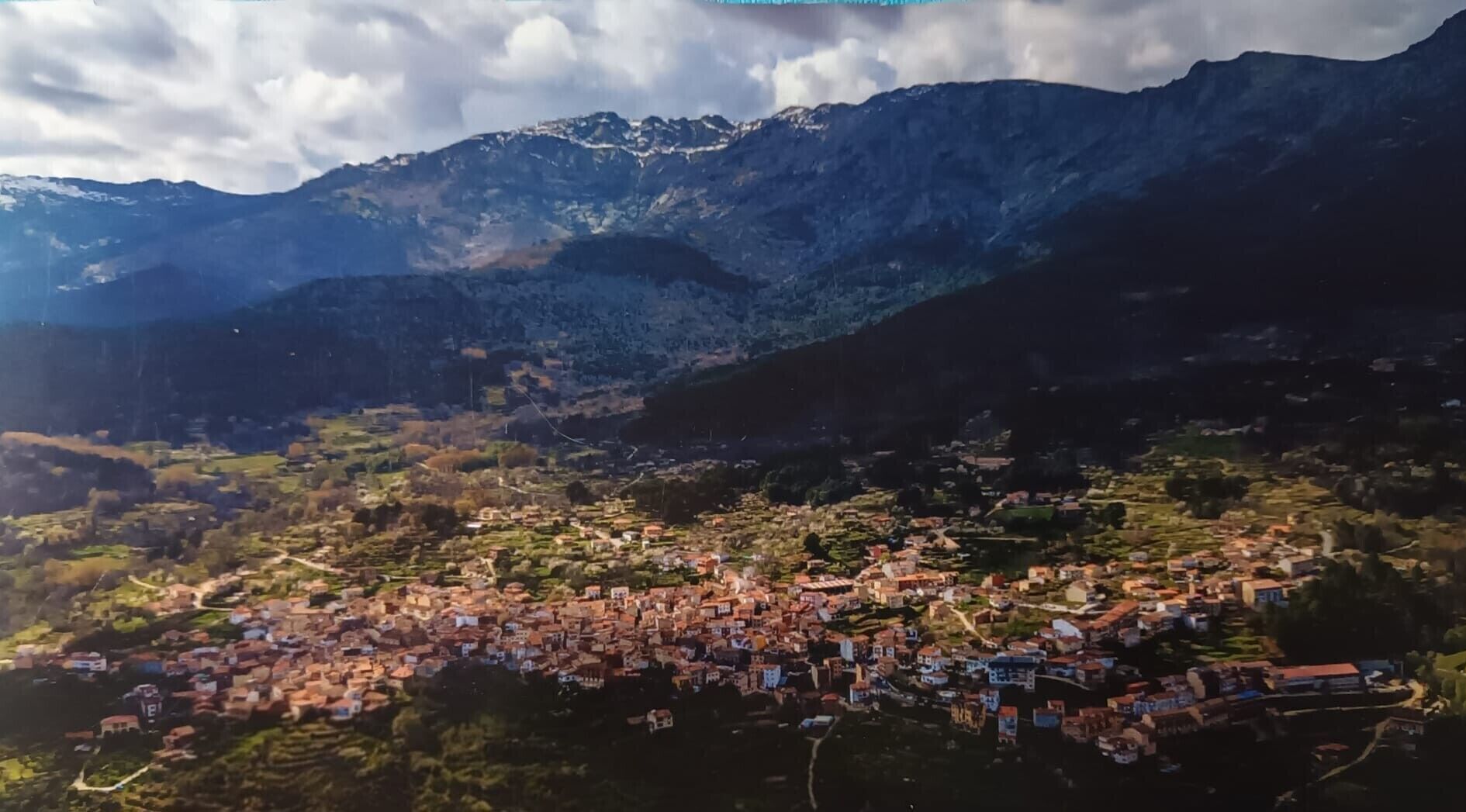 A mountainous landscape with a town nestled in the valley.
