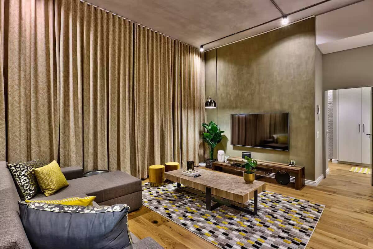 A modern living room with a sofa, coffee table, and TV.