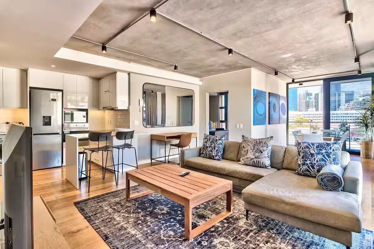 A modern apartment with a kitchen, dining area, and living room.
