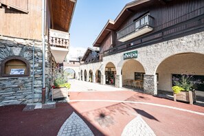 Un edificio de piedra con una tienda llamada 'Sherpa' y un cartel que dice 'A. LOUER'.