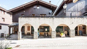 A building with a stone facade, wooden upper levels, and a sign indicating a post office.