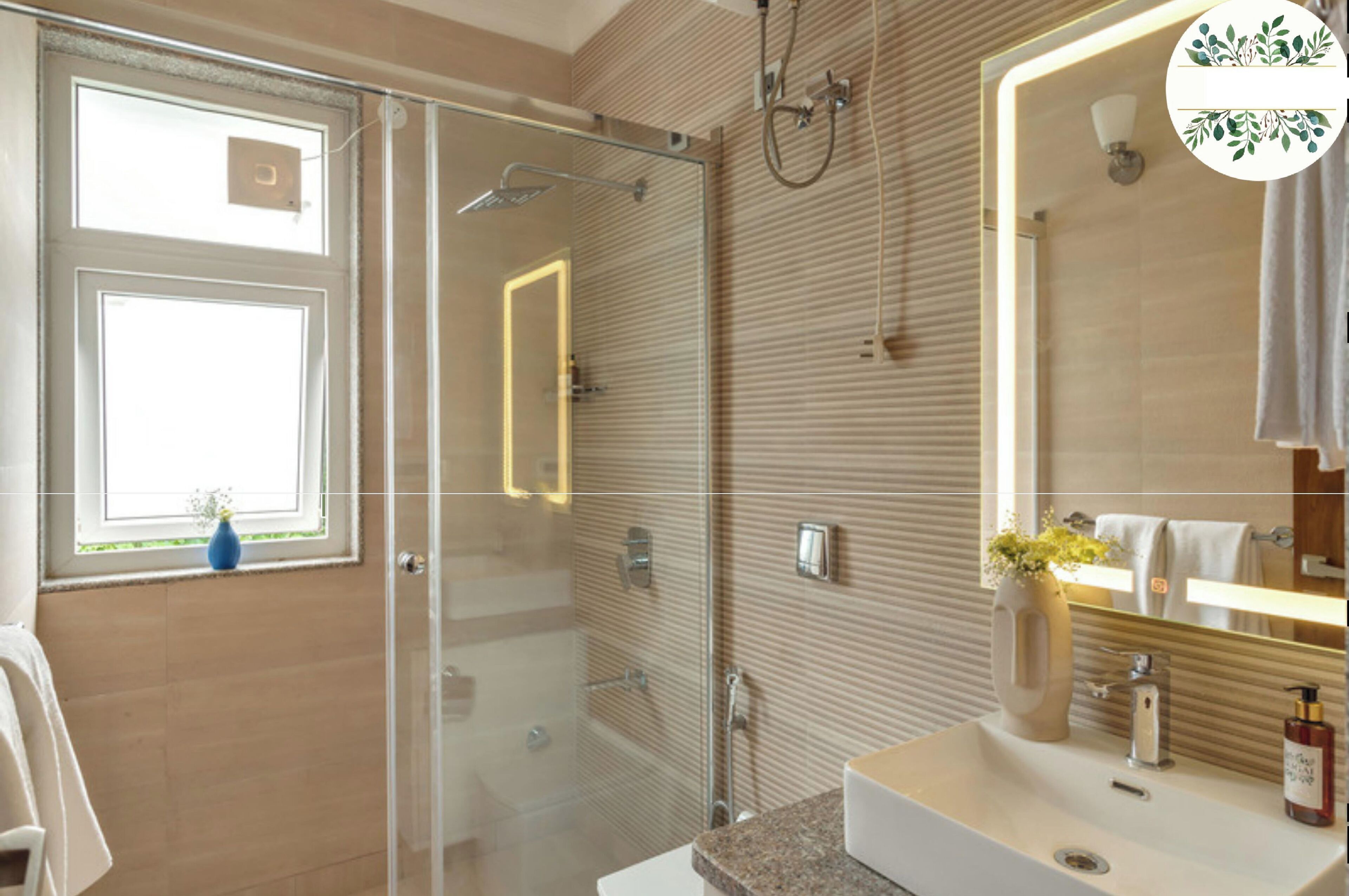 A modern bathroom with a glass shower enclosure, a large mirror, and a vanity with a sink and towel rack.