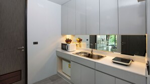 A modern kitchen with a built-in microwave, toaster, and sink. - Kata Pool Villa UTK5 for Beach Lovers  (Karon)