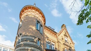 A historic building with a round tower, large windows, and a brick facade. - LubuNest3 | Terrace with barbecue & private parking space (Ludwigsburg)