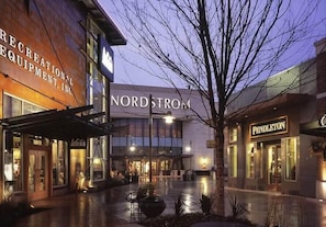 A building with 'NORDSTROM' signage, a 'RECREATIONAL EQUIPMENT, INC.' sign, and a 'PENDLETON' store.