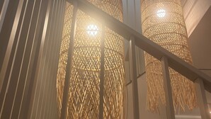 A staircase with a railing and two hanging lamps with a woven design. -  5-bedroom Vila Solini in the heart of Goriška brda with private pool (Kozana)