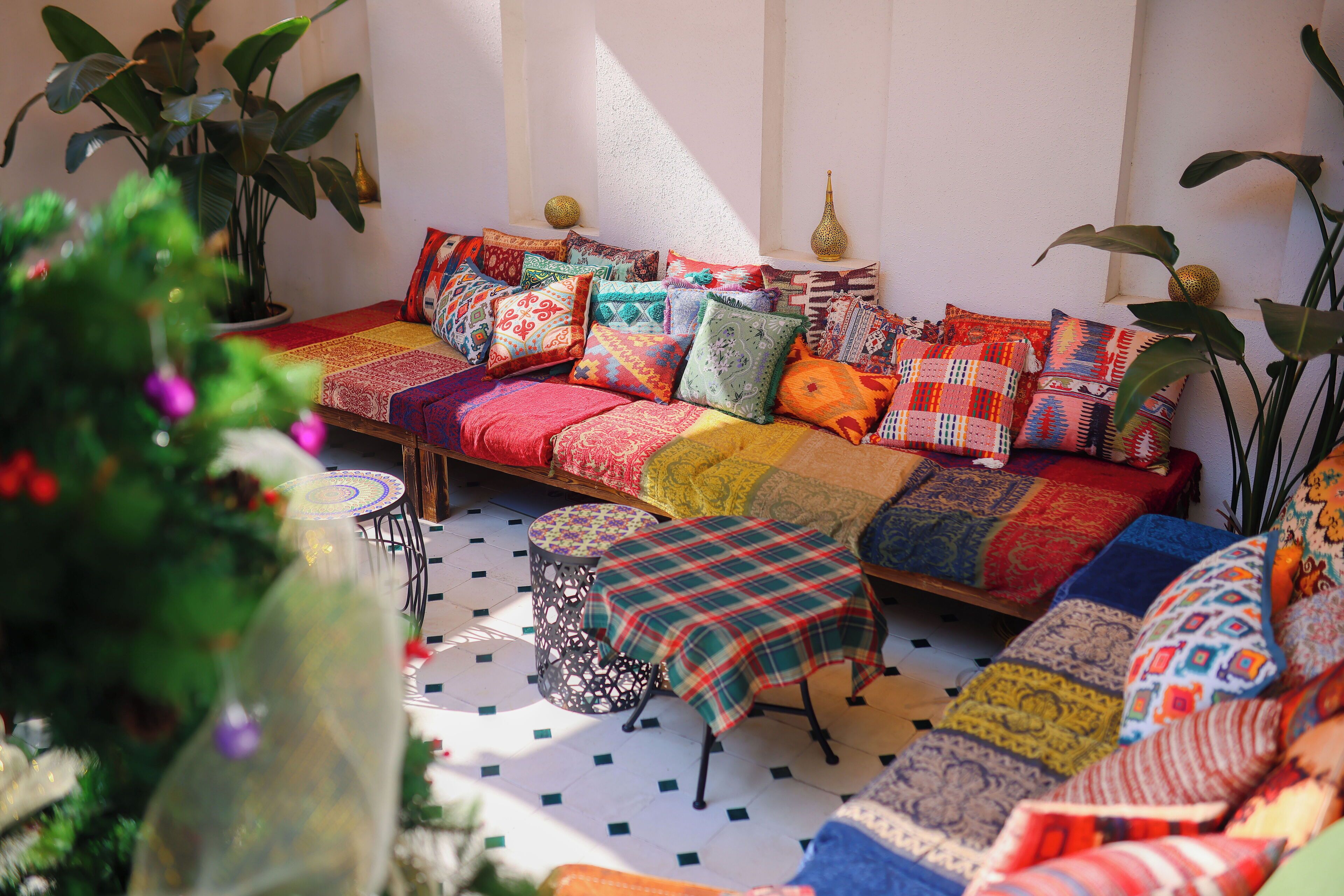 A cozy seating area with a patterned sofa, a small table, and decorative pillows.