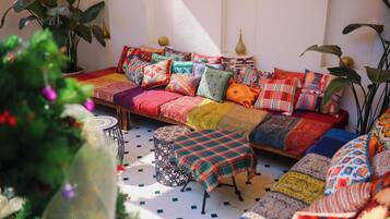 A cozy seating area with a patterned sofa, a small table, and decorative pillows.
