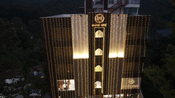 A building with a prominent sign reading "MALSI MIST" and a logo above the entrance. - Hotel Malsi Mist (Dehradun)