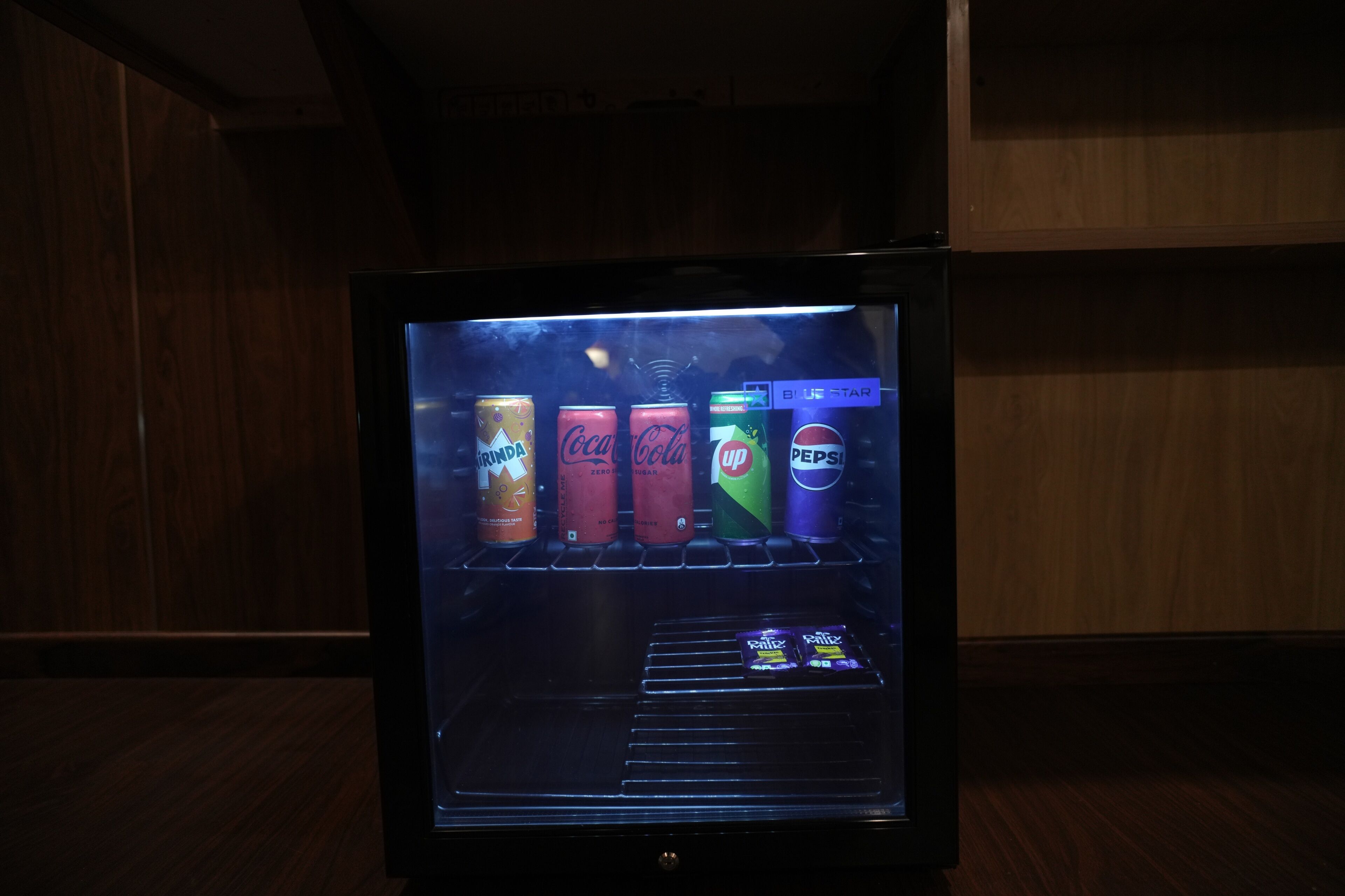 A vending machine with various beverage cans including Coca-Cola, Sprite, and Pepsi.