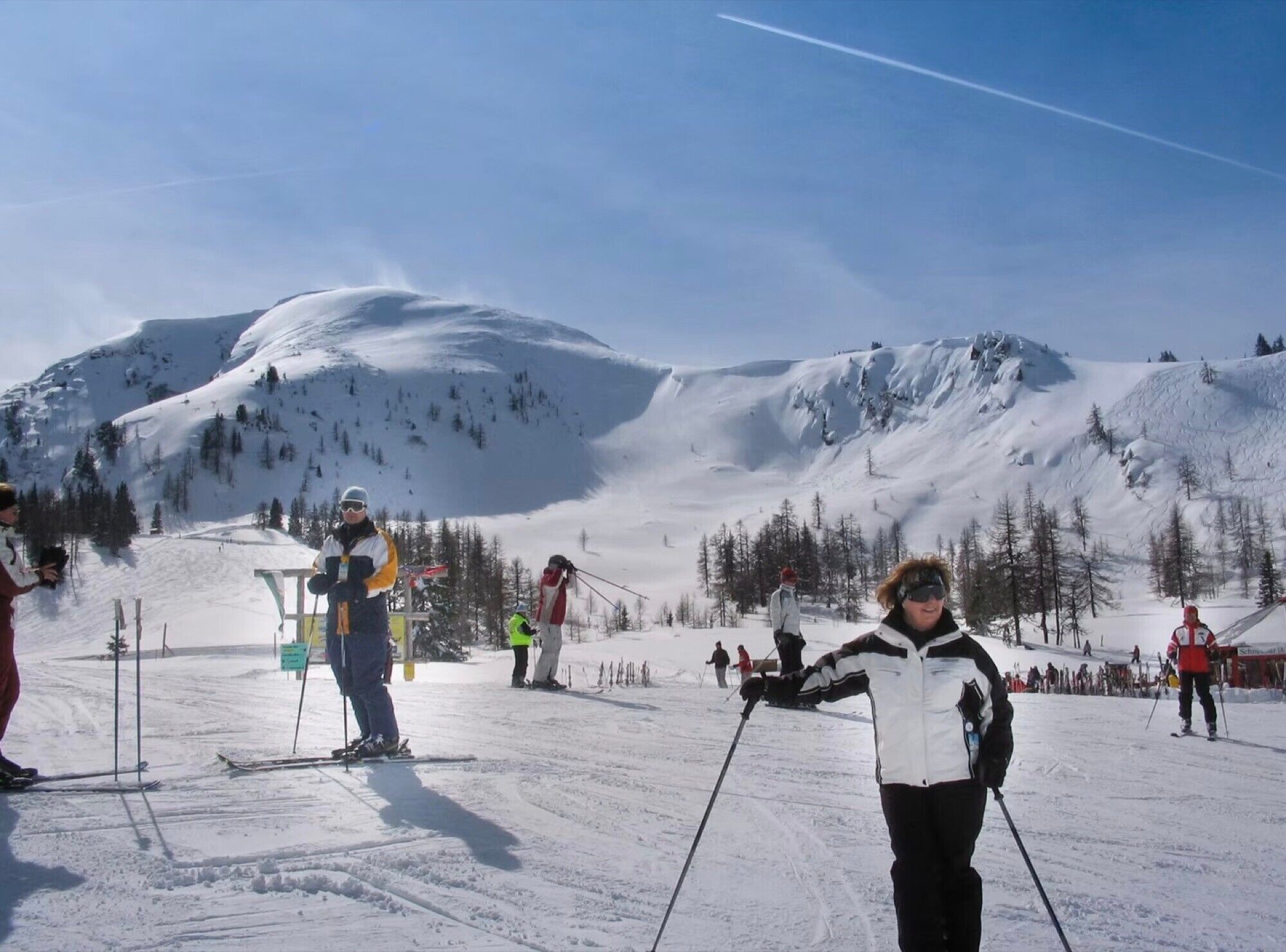 A ski slope with skiers and a chairlift.