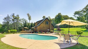 A wooden house with a pool and patio furniture. - Home Theater & Game Room: Home in Glen Wild! (Glen Wild)