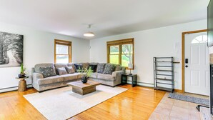 A living room with a sectional sofa, a coffee table, and a rug. - Home Theater & Game Room: Home in Glen Wild! (Glen Wild)