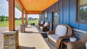 A covered patio area with wicker furniture and stone pillars. - Missouri River Retreat < 1 Mi to the Water! (Pierre)