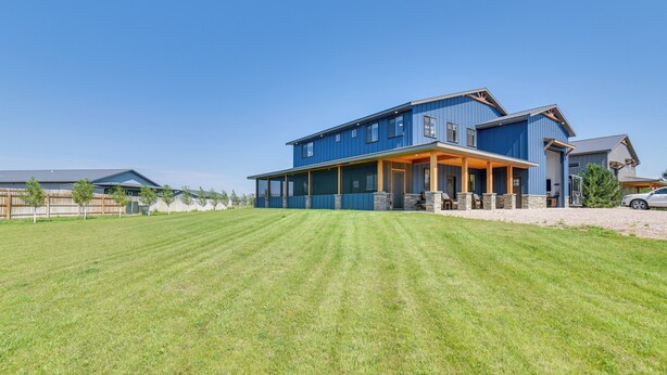 A large two-story house with a covered porch and a well-maintained lawn. - Missouri River Retreat < 1 Mi to the Water! (Pierre)