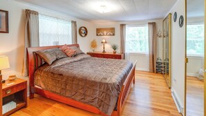 A bedroom with a wooden bed, a nightstand, a dresser, a mirror, and a window with curtains. - 4 Mi to Off-road Park: Beckley Area Townhome (Sophia)
