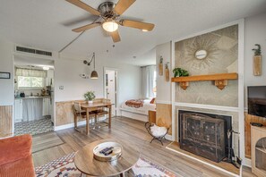 A spacious living room with a fireplace, a dining area, and a kitchen in the background. - 2 Mi to Ober Mountain: Mtn-view Studio w/ Balcony (Gatlinburg)