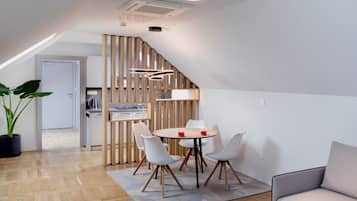 Deluxe Apartment | Living area | 100-cm LCD TV with cable channels