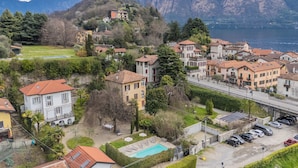 A residential area with houses, a swimming pool, and a view of mountains and a lake. - Villa Olga With Private Pool by Rent all Como (Tremezzina)