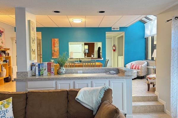 View of living room and dining area, through to the kitchen.