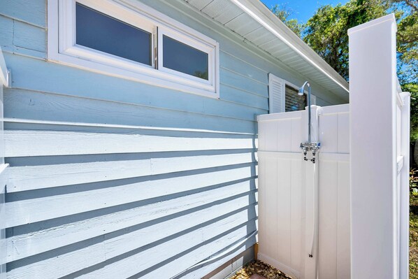 A house with a white exterior and a white fence.