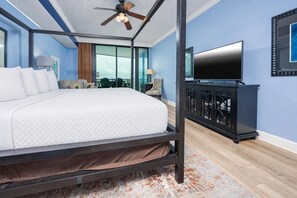 A bedroom with a bed, a ceiling fan, a TV, and a view of the outdoors. - Phoenix Ix 705 3 Bedroom Condo (Orange Beach)