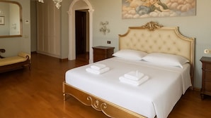A bedroom with a large bed, a chandelier, a painting, and a mirror. - Villa Monaco: Double Room in Villa with Pool, Hot Tub (Mosciano Sant'Angelo)