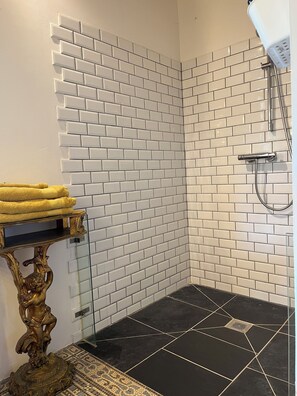 Shower, hair dryer, towels, toilet paper