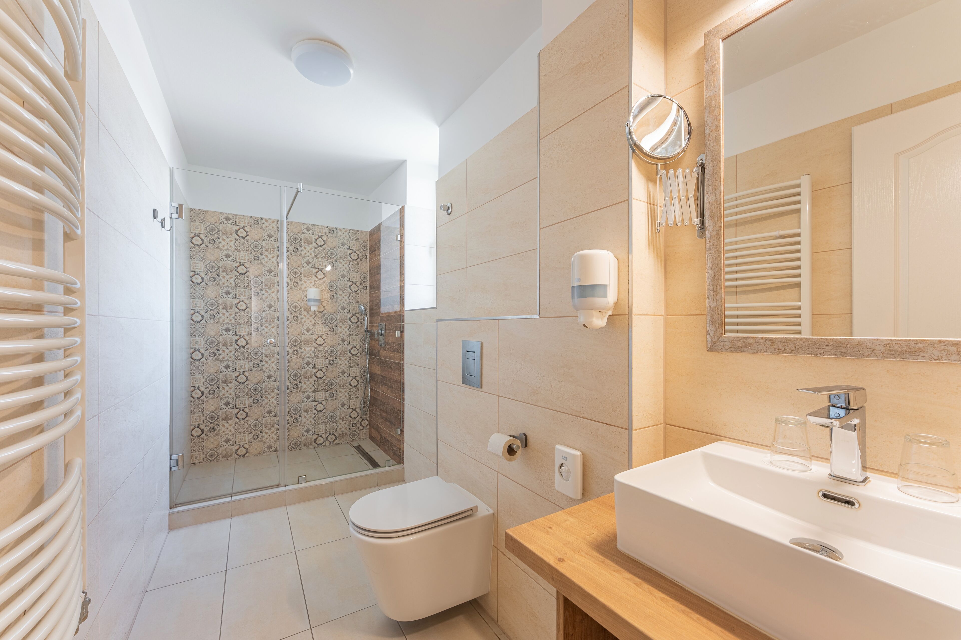 A modern bathroom with a shower, toilet, and sink.
