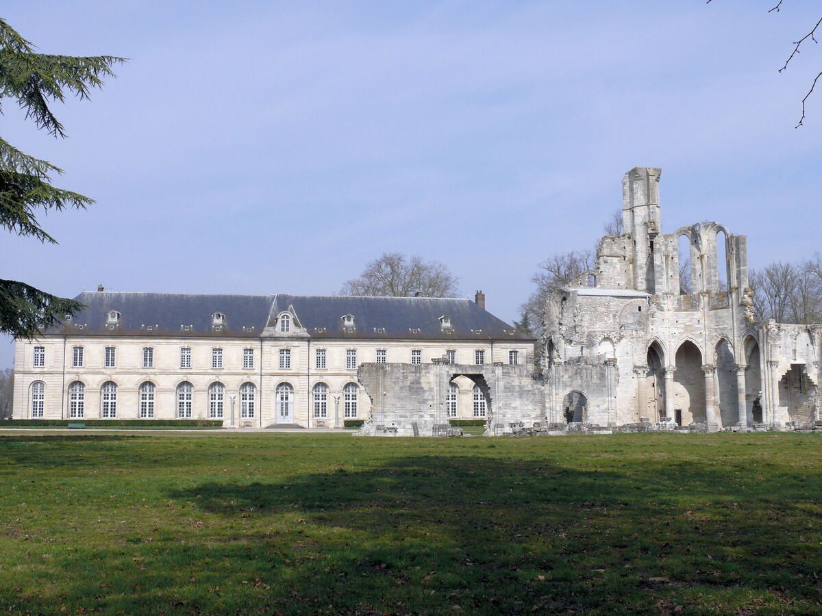 A historic building with a symmetrical facade and a large courtyard.