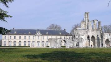 A historic building with a symmetrical facade and a large courtyard.