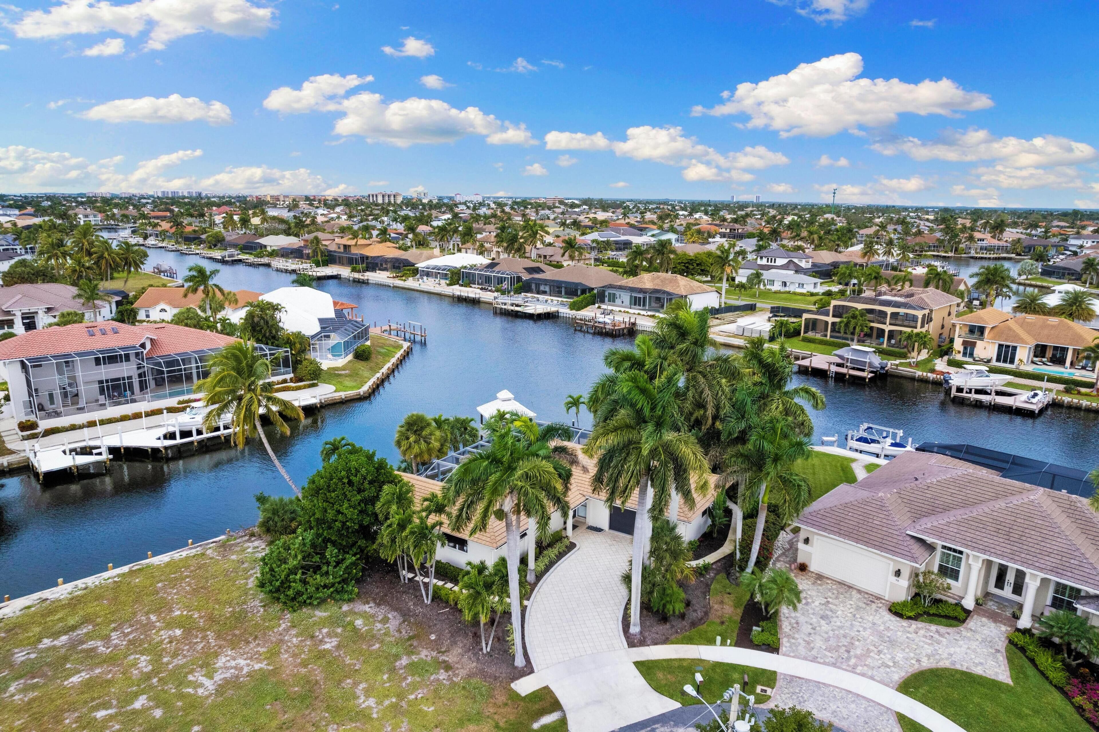 A residential area with houses, a marina, and a waterway.