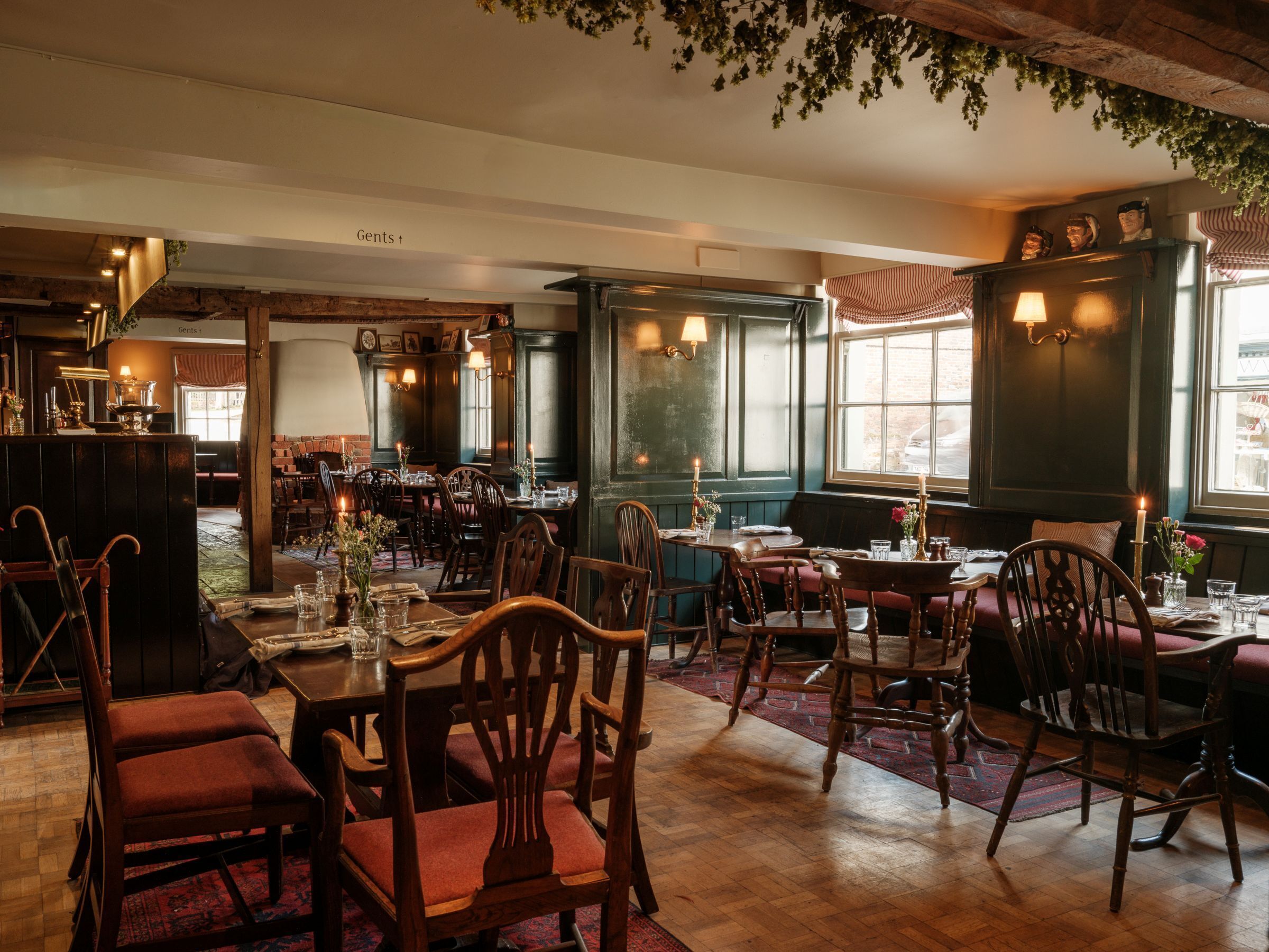 A cozy restaurant with wooden furniture, candle-lit tables, and a rustic ambiance.