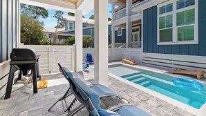 A covered outdoor area with a pool, lounge chairs, and a barbecue grill. - Bikes, Private Pool, Putting Green, Close to Seaside and Beach (Santa Rosa Beach)