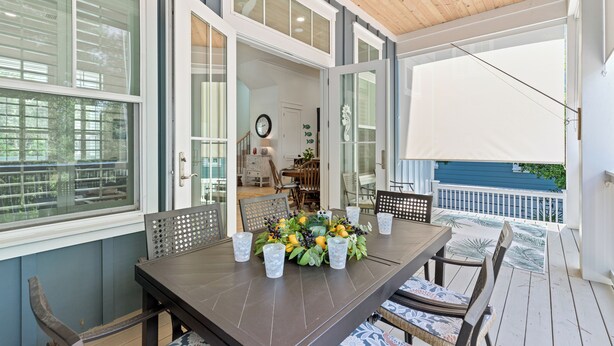 A covered patio with a dining table set for four, surrounded by chairs. - Bikes, Private Pool, Putting Green, Close to Seaside and Beach (Santa Rosa Beach)