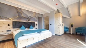 A modern bedroom with a wooden bed, a large abstract wall art piece, and a wooden wardrobe.