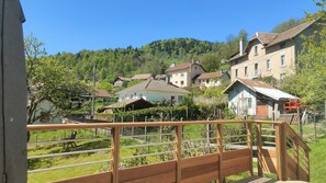 A residential area with houses, a wooden fence, and a hill in the background.