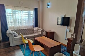 Comfort Apartment, City View | Living area | 24-inch Smart TV with digital channels