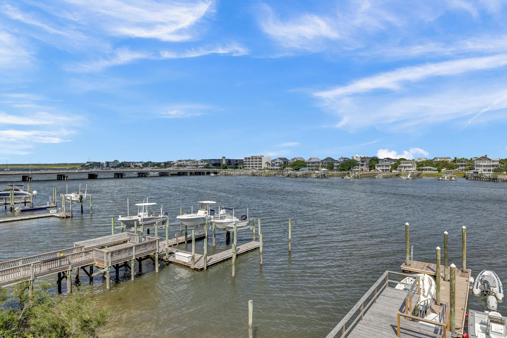 A marina with docked boats, wooden piers, and a clear view of the waterfront.