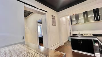 Una cocina moderna con gabinetes negros, un lavamanos de acero inoxidable y un escurreplatos.