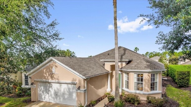 A single-story house with a garage, a small porch, and a well-maintained lawn. - EV_416 - 4 Bed 3 Bath with Screened-In Private Pool, Games Room (Davenport)