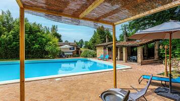 Seasonal outdoor pool, open 10:00 AM to 7:00 PM, pool loungers