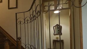 A staircase with a wrought iron railing leading to a landing. - Casa Prado Suites Hotel (La Paz)
