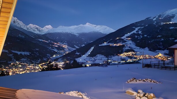 A snowy mountain landscape with a town in the valley below. - Apartment 'Marmotta' with Mountain View, Shared Garden and Wi-Fi (Oga)