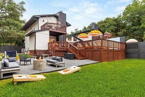 A backyard with a deck, outdoor seating, and a fire pit. - Pool, Firepit, Mins to DT, SXSW, ACL, Sleeps 6 (Austin)